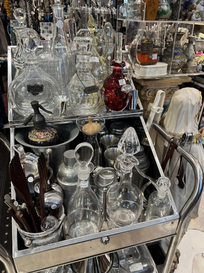 Vintage crystal decanters arranged on a drinks trolley at Uuli's Unique & Unusual
