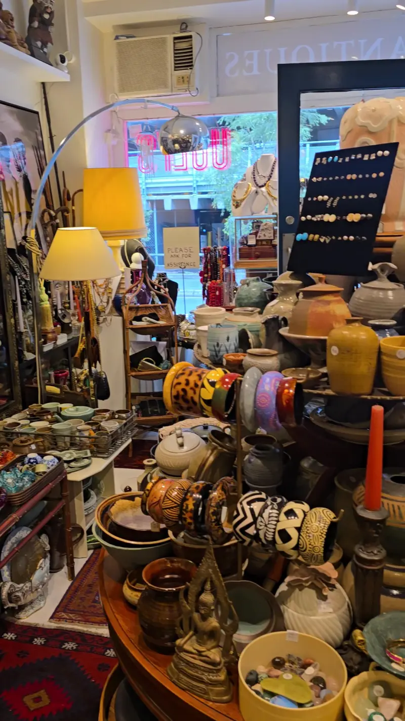 Vintage lamps glowing among pottery and jewellery inside Uuli's Unique & Unusual, Manly